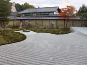 zen garden at kōdai-ji temple overlooked by the kamakura big budha