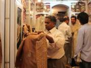 man getting fitted for his marriage sherwani